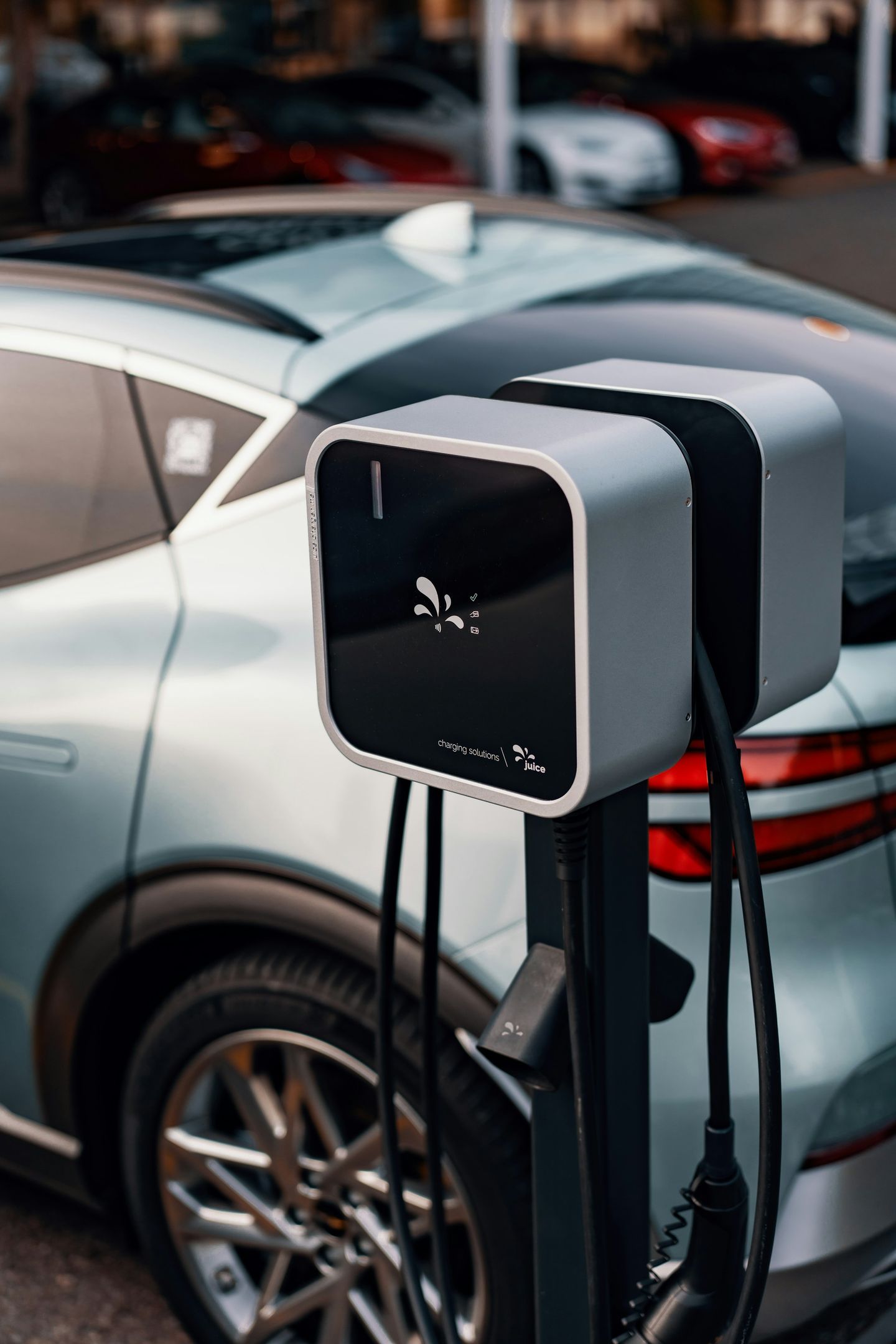 An electric vehicle parked beside a charging unit.